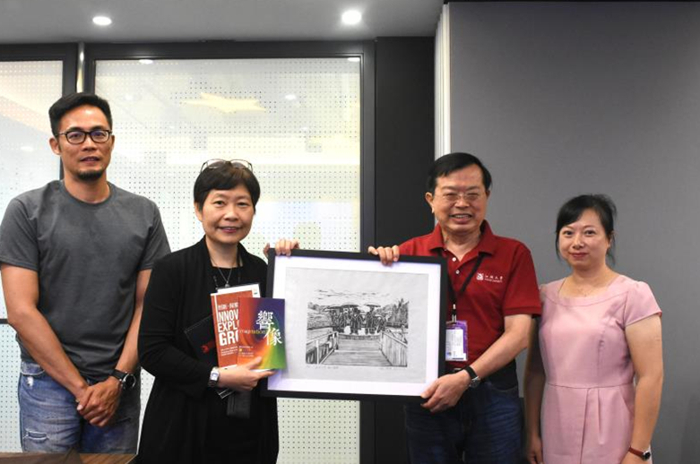 李奥贝纳广告公司Group Managing Partner冉龙华(左二),接受我院教授罗文坤(右二)致赠礼物以表谢意。图右为杜式敏书记,图左为策略长兼人资长张治亚。 (陈楚红摄)